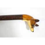 A walking stick with carved and painted fox head handle,