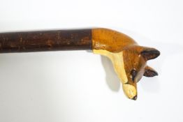 A walking stick with carved and painted fox head handle,