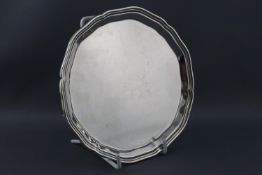A silver plain salver, of small proportions, raised on three feet, Sheffield 1936, 15cm high,