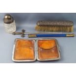 A silver mounted crocodile skin card case with applied monogram and crest with two pieces of....