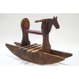 A pine child's rocking horse, with leatherette seat, overall 67cm high x 123 cm,