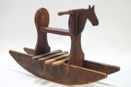 A pine child's rocking horse, with leatherette seat, overall 67cm high x 123 cm,