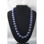 A single strand of round uniform lapis lazuli beads, measuring from 14.0mm to 15.0mm.