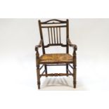 A 19th century child's beech chair with rush seat,