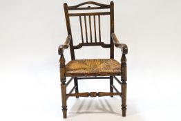 A 19th century child's beech chair with rush seat,