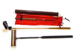 A croquet mallet, golf club and fishing rod