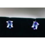 A white metal pair of single stone tanzanite stud earrings, approximate 1.20ct.