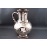 A Victorian Britannia silver water jug, with moulded lip to the cylindrical neck,