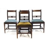 Four early 19th century mahogany dining chairs with tip in seats