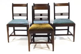 Four early 19th century mahogany dining chairs with tip in seats