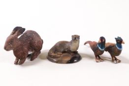 Two cold painted metal figures of pheasants, a rabbit and an otter on agate base,