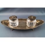 A navette shaped silver dish with with two silver covered ink bottles