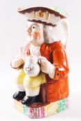 A 19th century Staffordshire pottery Toby jug, painted in enamels, modelled holding a jug and glass,