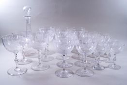 A suite of cut glass engraved with flowers and butterflies, comprising of a decanter and stopper,