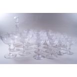 A suite of cut glass engraved with flowers and butterflies, comprising of a decanter and stopper,