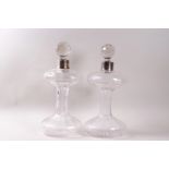 A pair of cut glass decanter, each with silver collars, cut globular stoppers and star cut bases,