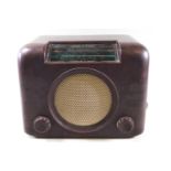 A Bakelite cased Bush radio, the front with central speaker and two control knobs.