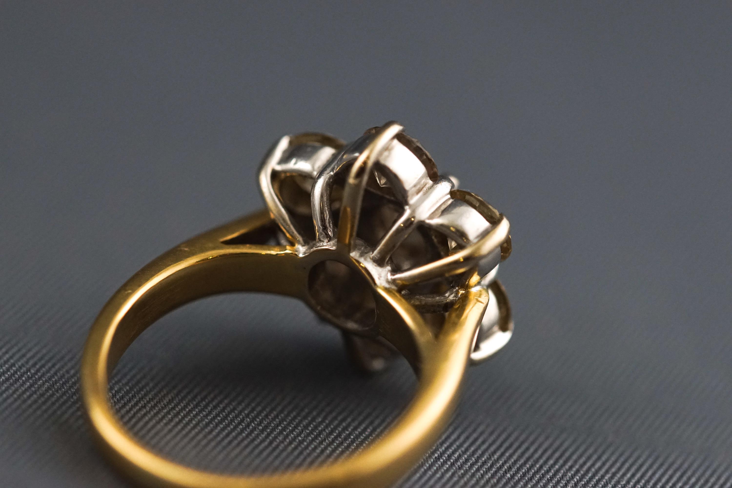 A yellow and white metal seven stone diamond flower ring, Estimated total weight of 2.50 carats. - Image 6 of 7