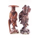 Two Japanese root carved figures, one holding a fish and a knap sack, 36cm high,