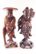Two Japanese root carved figures, one holding a fish and a knap sack, 36cm high,