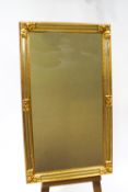 A 20th century mirror with gilt frame and mirrored panels,