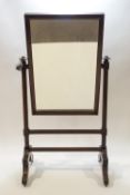 A Victorian mahogany cheval mirror on splayed leg base,