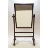 A Victorian mahogany cheval mirror on splayed leg base,