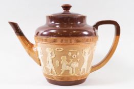 A Doulton stoneware teapot with applied Egyptian figures, impressed marks,