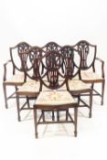 A set of six Sheraton style shield back mahogany dining chairs with Prince of Wales feather carved