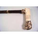 A late 19th century walking stick with ivory and 14k gold plated fitments,