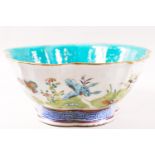 A Canton enamel bowl, painted with butterflies in a landscape, with Daoguang mark,