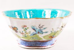 A Canton enamel bowl, painted with butterflies in a landscape, with Daoguang mark,