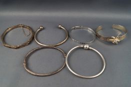 A selection of six sterling silver bangles.