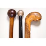 A three wooden knobbed walking sticks,