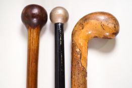 A three wooden knobbed walking sticks,