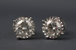 A white metal pair of single stone diamond studs.