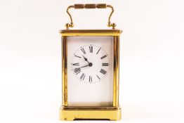 A brass framed carriage clock with enamel dial,