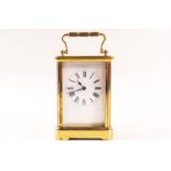 A brass framed carriage clock with enamel dial,