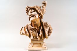 A 19th century hard paste bust of a man wearing a hat, on flared socle base,
