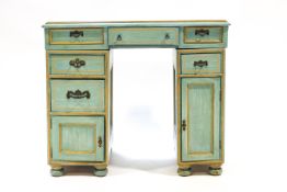 A small painted kneehole desk/dressing table finished in blue and cream,