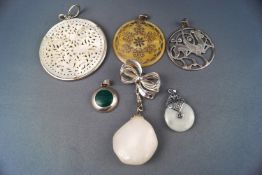 A selection of six pendants consisting of mother of pearl and rock crystal set in silver mounts,