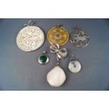 A selection of six pendants consisting of mother of pearl and rock crystal set in silver mounts,