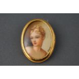 A miniature watercolour portrait brooch, in yellow metal frame, stamped 800 (silver gilt)