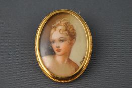 A miniature watercolour portrait brooch, in yellow metal frame, stamped 800 (silver gilt)