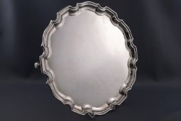 A silver salver with Chippendale border, raised on three feet, Sheffield 1994, 26cm diameter,