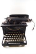 A 10" Smith and Corona typewriter with original cover