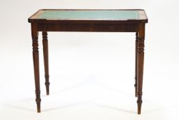 A Regency mahogany veneered rectangular writing table with brass set corners,
