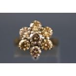A yellow and white metal seven stone diamond flower ring, Estimated total weight of 2.50 carats.