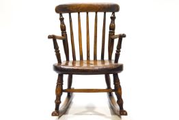 A 19th century child's and elm chair with turned back and solid seat