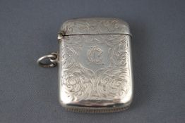 A silver vesta case with scrolling engraving,